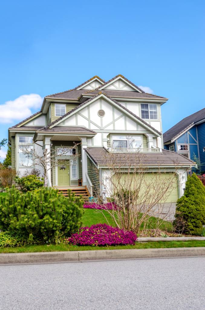 Suburban house exterior painted green and white