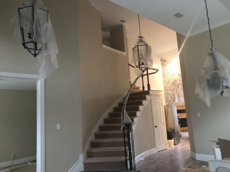 Curved staircase and foyer after interior painting