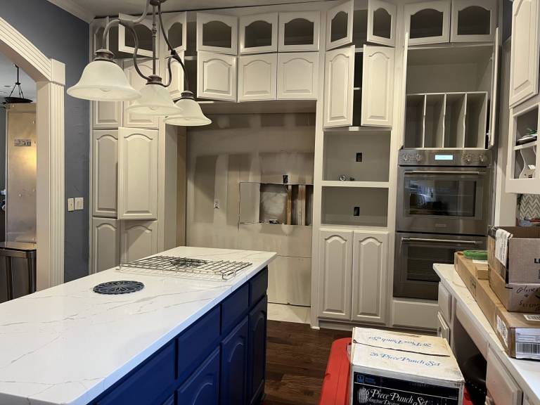 Kitchen remodel with white cabinets and quartz island