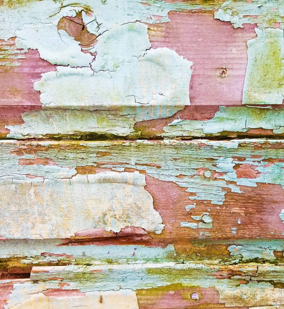 Weathered, peeling paint on wood siding